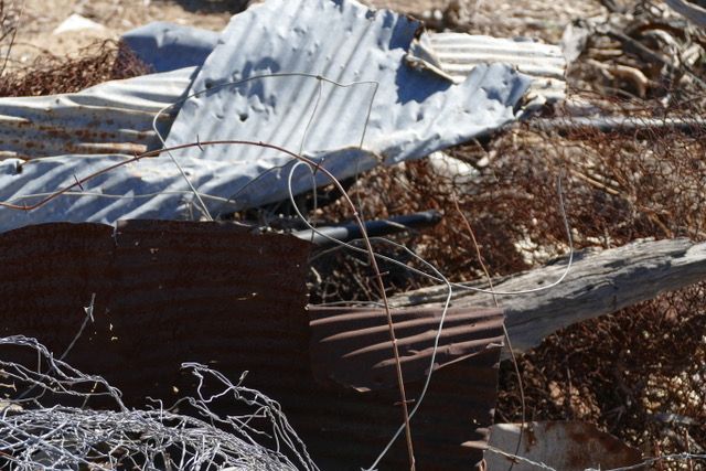 Photo of wire and corrugated iron in dry grass