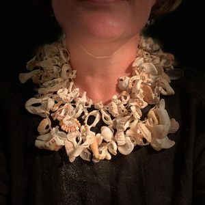 Melinda Young wears a necklace made of shells and other found materials